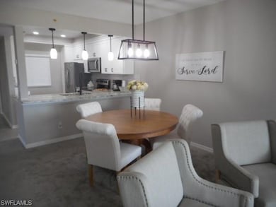 Dining area featuring baseboards and carpet