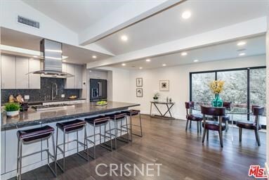 Previously staged photos of kitchen eating area w/sliders open to outdoors.