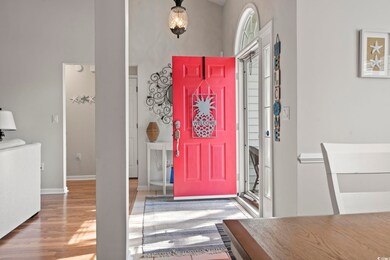 Entryway with baseboards, a high ceiling, and wood