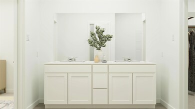 Bathroom with double vanity, baseboards, and a sin