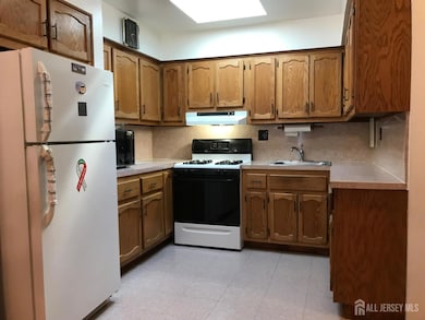Convenient kitchen with ample l counter soace and cabinetry