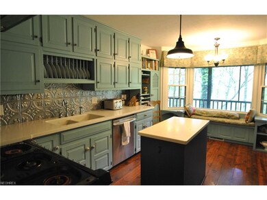 The kitchen includes the stainless steel refrigera