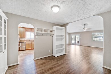 A step down from the foyer leads into this flexible-use space that was designed to serve as a dining room but could also be utilized as a home office. It is open and accessible to the foyer, kitchen, and family room.