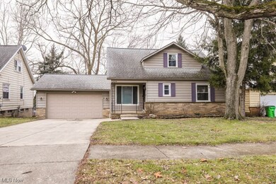 View of front facade with a front lawn and a garage