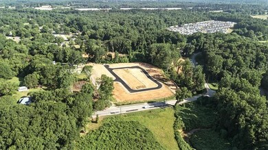 Aerial view of property and surrounding area with a heavily wooded area