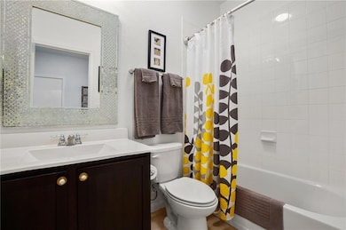 Bathroom featuring toilet, vanity, and shower / b