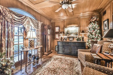 Beautiful wood paneled study overlooks front porch. One of the favorite rooms for sitting and visiting with friends and reading books.