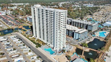 Aerial view of a pool area and a nearby body of water