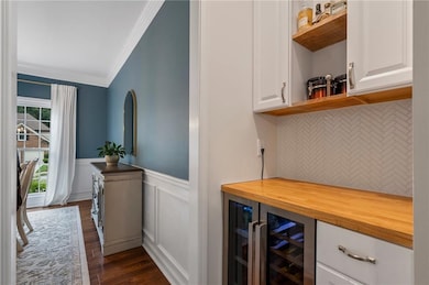 Bar with wine refrigerator.