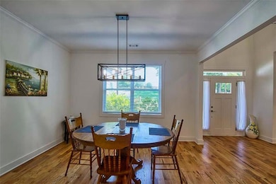 Welcome to this open concept plan with glistening hardwoods throughout