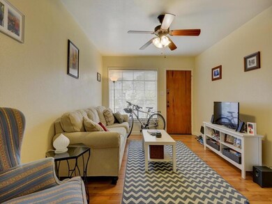 Living room with a ceiling fan and wood finished 