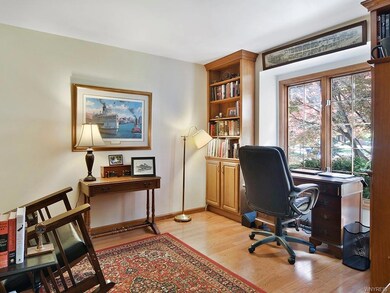 Den has Hardwood Floors and built in bookcases