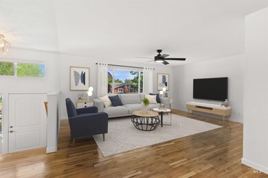 Living area with plenty of natural light, wood finished floors, and a ceiling fan