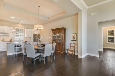 Dining room featuring a raised ceiling, baseboard