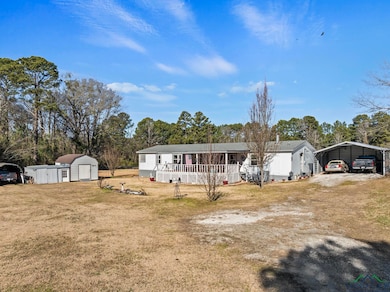 View of front of house featuring a storage shed, a