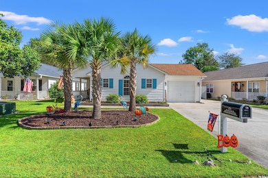 Ranch-style home featuring double driveway,  front lawn, a garage, and shingled roof