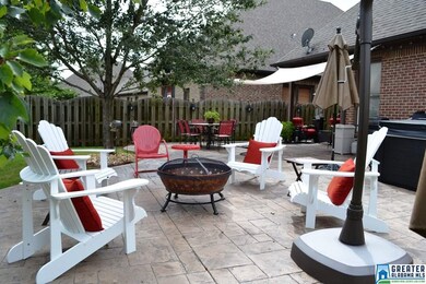 COVERED PATIO WITH LARGE EXTENDED STAMPED-CONCRETE