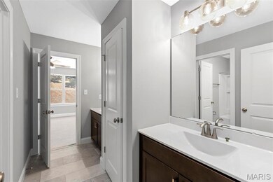 Bathroom with shower / tub combination, ceiling fan, and vanity