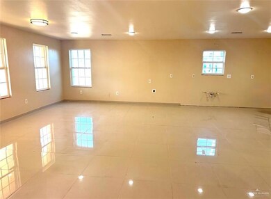 Unfurnished room featuring baseboards and light tile patterned floors