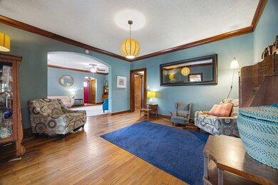 Living room featuring arched walkways, hardwood / 