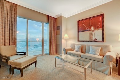 Carpeted living area featuring crown molding