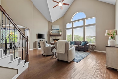 Living area featuring stairs, ceiling fan, high v
