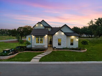 Modern home featuring stone siding, a shingled ro