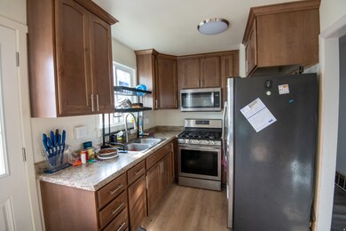 Kitchen featuring appliances with stainless steel finishes and light wood-style flooring