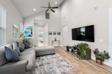 Living area with ceiling fan, light wood-type flo