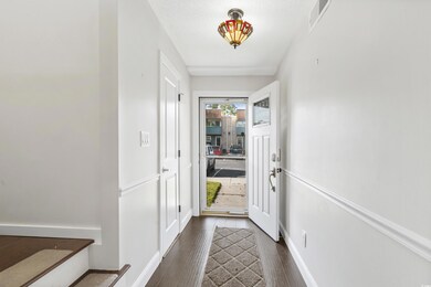 Entryway with dark hardwood / wood-style flooring 