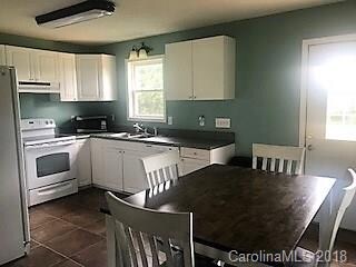 spacious kitchen and dining area with tile floors,