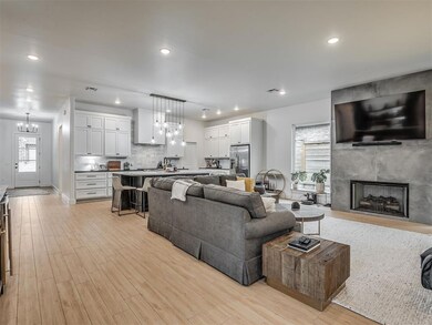 Living area featuring recessed lighting, a fireplace, and wood finished floors