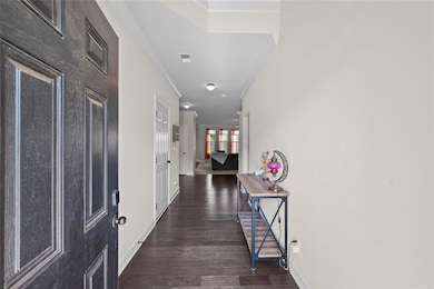 Corridor featuring crown molding, baseboards, visi