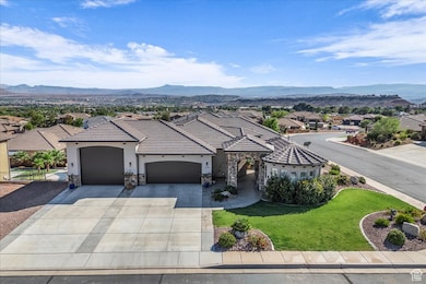 View of front of home featuring stone siding, a garage, a front lawn, a residential view, and driveway