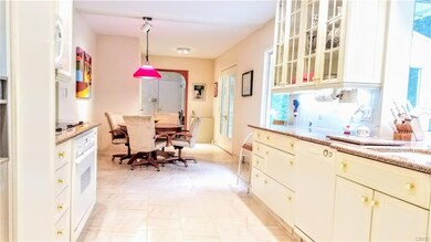 Different angle of kitchen, showcasing clean white