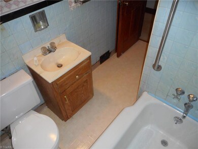 Main Hall Bathroom: Room features include vinyl flooring for easy cleaning, a window for natural lighting and the tub/shower with tiled walls.