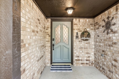View of exterior entry with brick siding