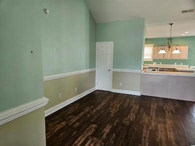 Unfurnished living room with dark wood-type flooring and recessed lighting