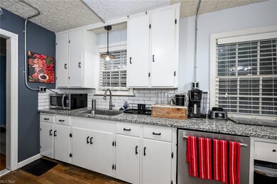 Kitchen featuring dark hardwood flooring, dark sto