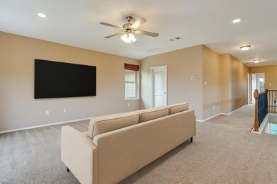 Living area featuring light carpet, baseboards, a