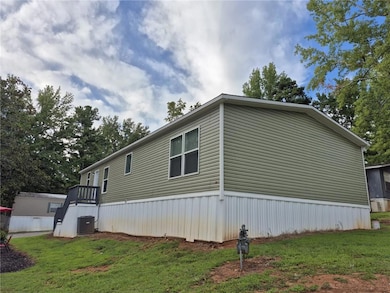 View of property exterior with a yard