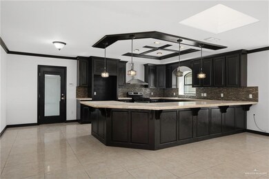 Kitchen with tasteful backsplash, pendant lighting, ornamental molding, stainless steel electric stove, and wall chimney range hood