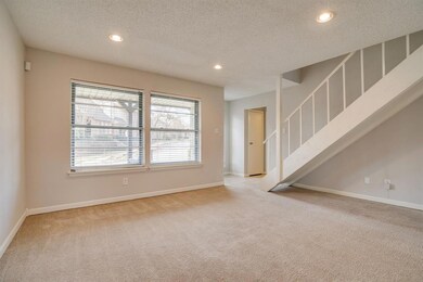 Front door is on the other side of the two windows