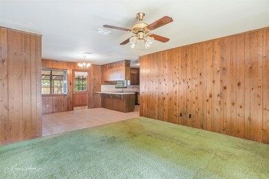 Kitchen with ceiling fan with notable chandelier, 