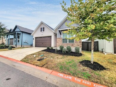 View of front of home with driveway and brick siding