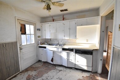 Kitchen featuring a wainscoted wall, visible vents