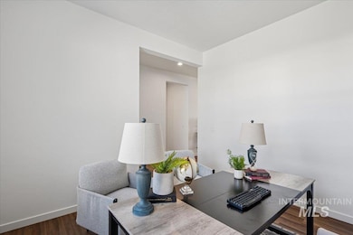Office area with dark wood-style floors and recessed lighting