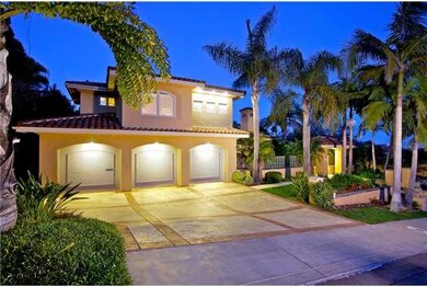 Lush, tropical landscaping accents this beautiful La Playa home