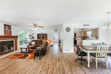 Living area with ceiling fan with notable chandeli
