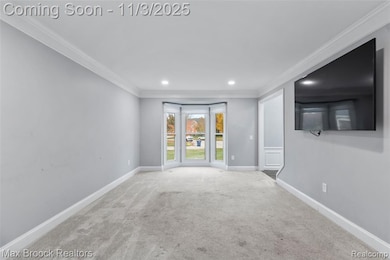 Spare room with crown molding, carpet, and recessed lighting